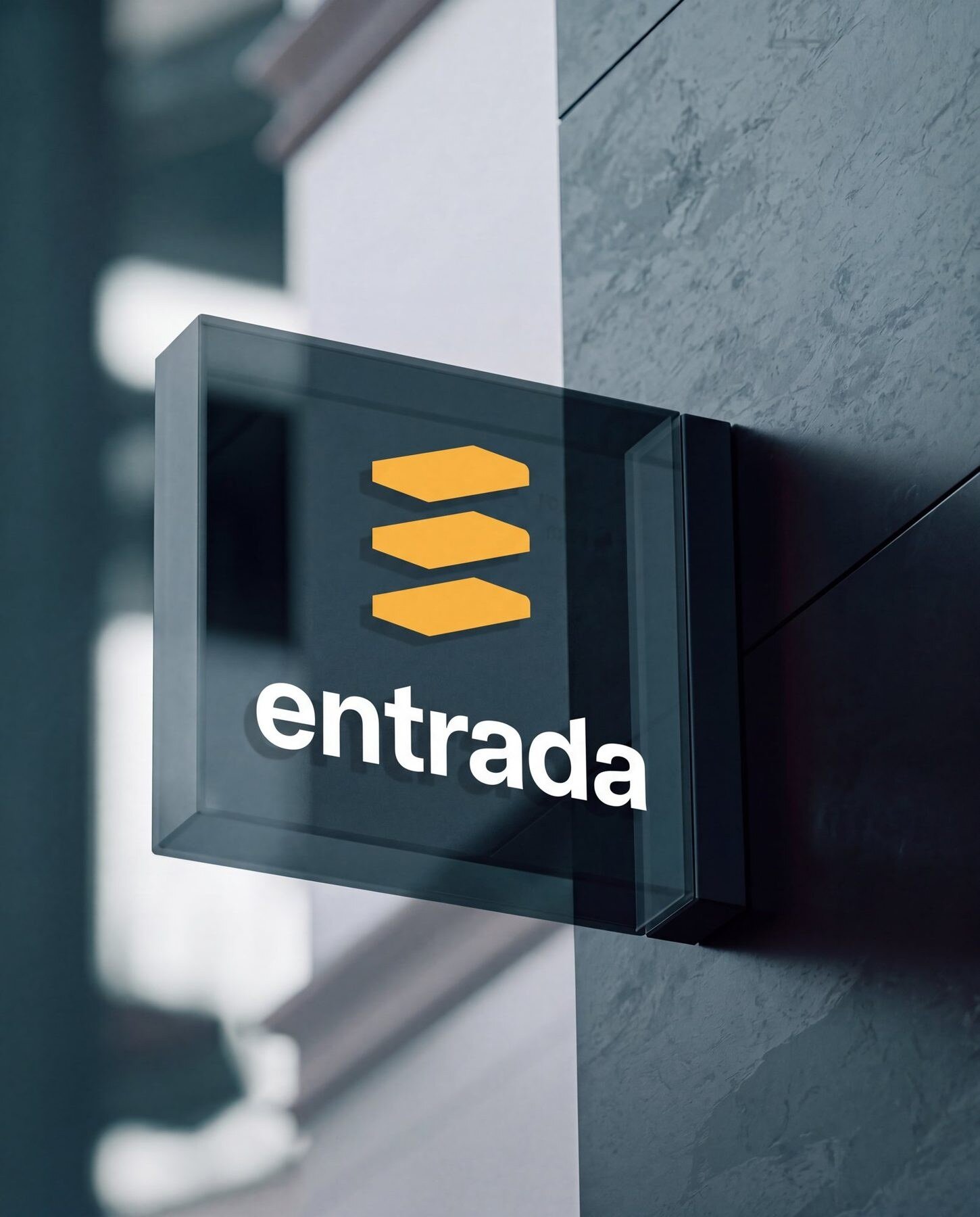 Glass sign on a stone wall with the Entrada mark in amber and the wordmark in white