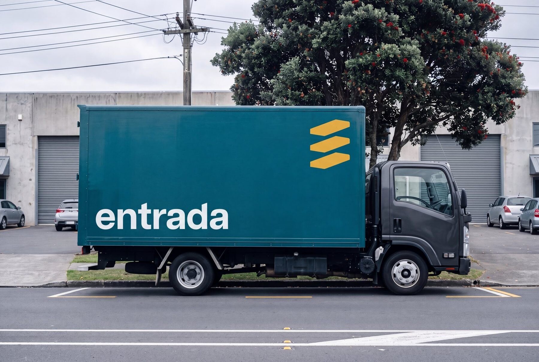 Teal delivery truck with the Entrada mark in amber and the wordmark in white